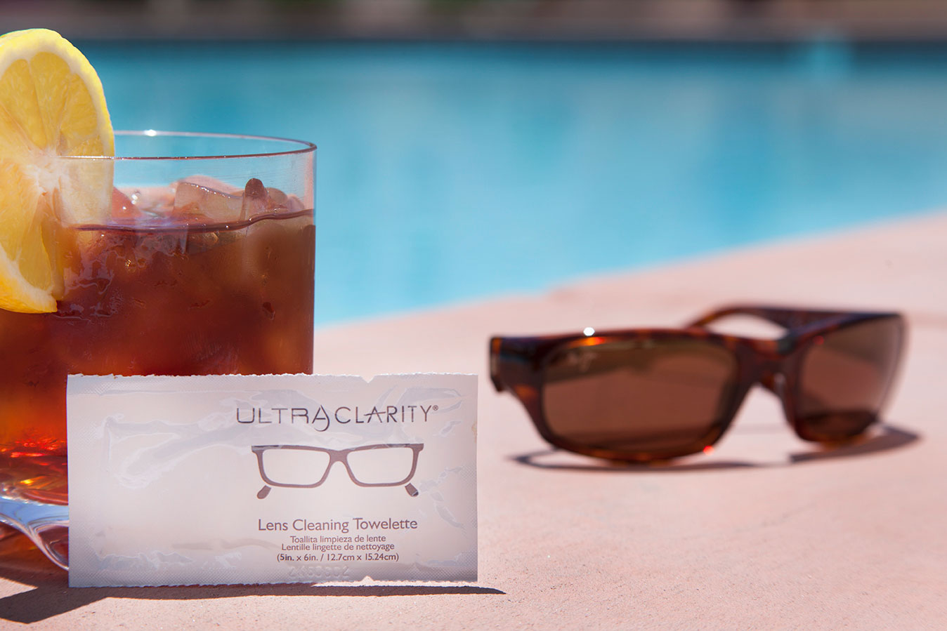 Lens Cleaning towelette, drink & sunglasses by the pool at The Hacienda in Gay Palm Springs